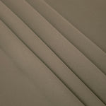 Layered folds of Warm Stone Taupe 100% mechanical polyester crepe showing body and gentle construction stretch