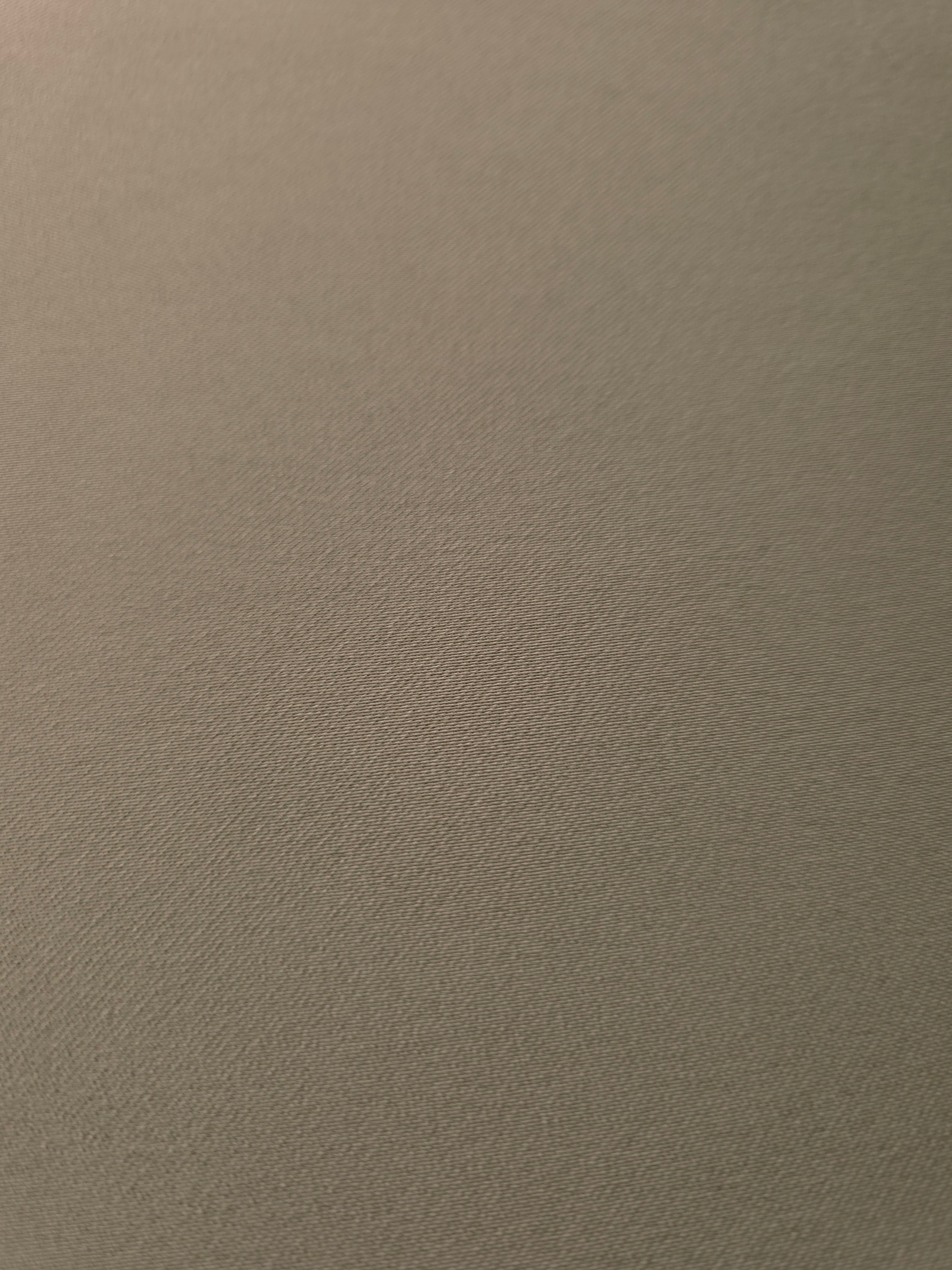 Texture detail of Warm Stone Taupe mechanical polyester crepe, a smooth woven fabric with a soft silky hand