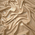 Draped Warm Taupe Beige metallic foiled spandex showing reflective folds and flexible flow for dresses, stagewear and occasion looks