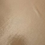 Close-up of Warm Taupe Beige metallic foiled spandex showing reflective surface texture and the detailed shimmer finish
