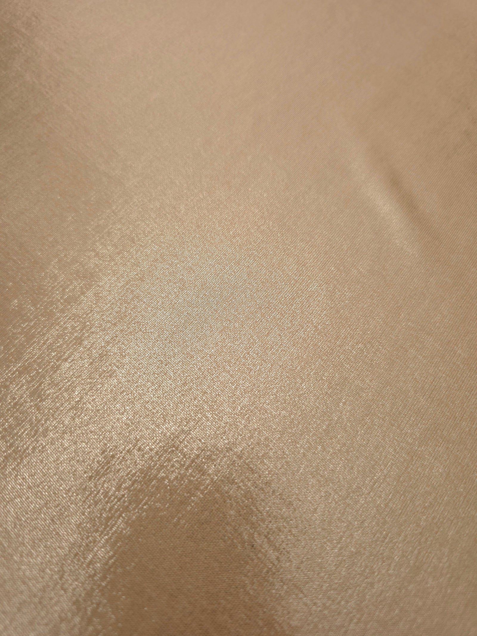 Close-up of Warm Taupe Beige metallic foiled spandex showing reflective surface texture and the detailed shimmer finish