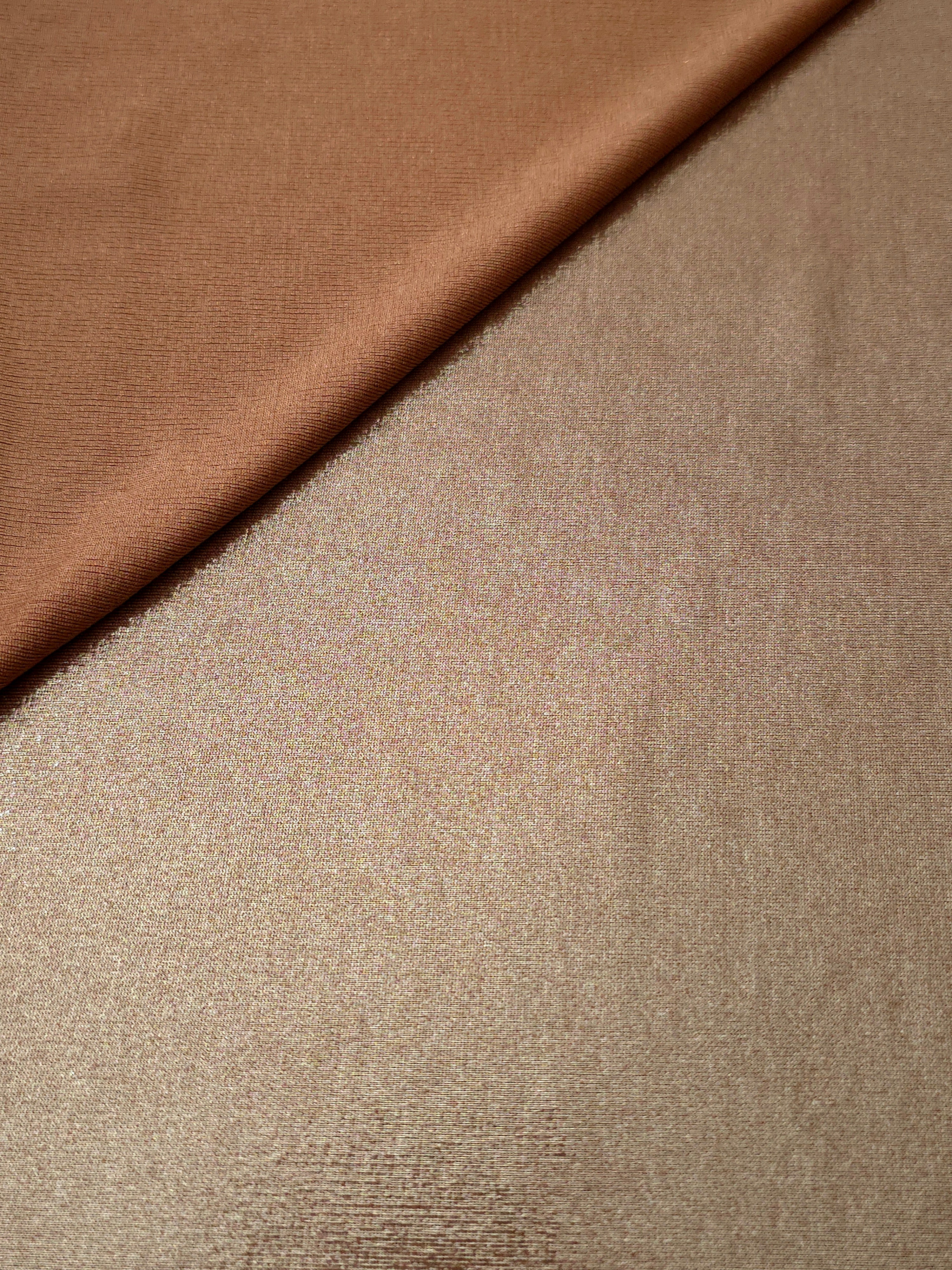 Soft fold of Warm Taupe Beige metallic foiled spandex highlighting reflective sheen and supple movement for dresses and stagewear
