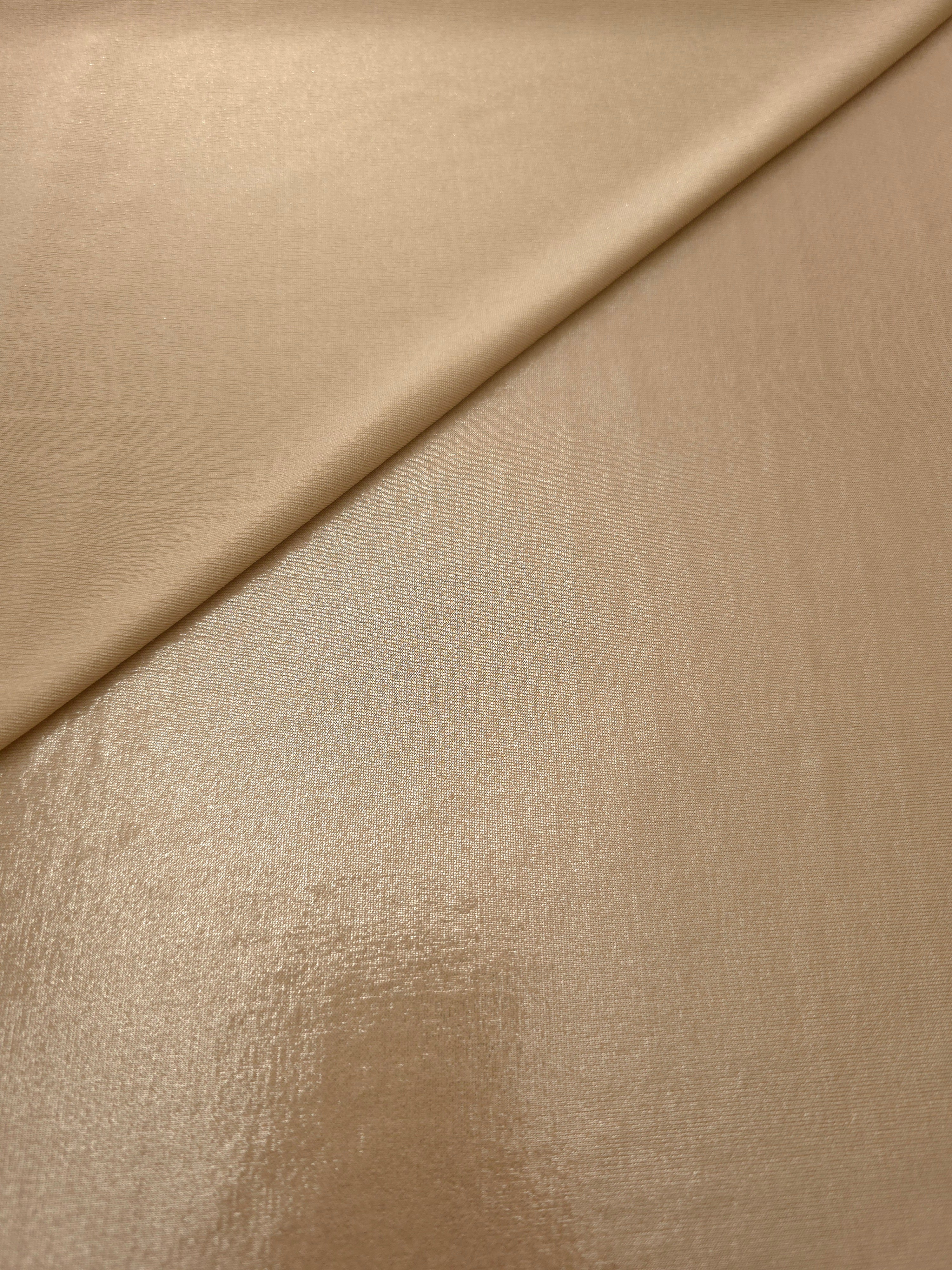Warm Taupe Beige shimmer spandex in a soft fold, showing metallic foil sheen and flexible drape for tops, skirts and costumes